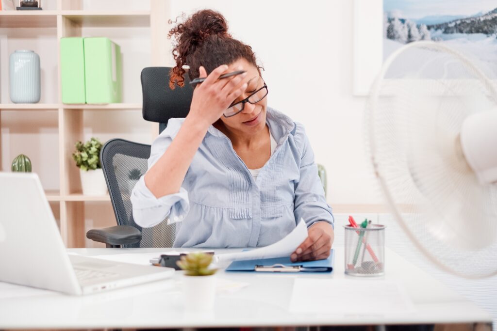 Woman sweating and suffering for summer heatwave