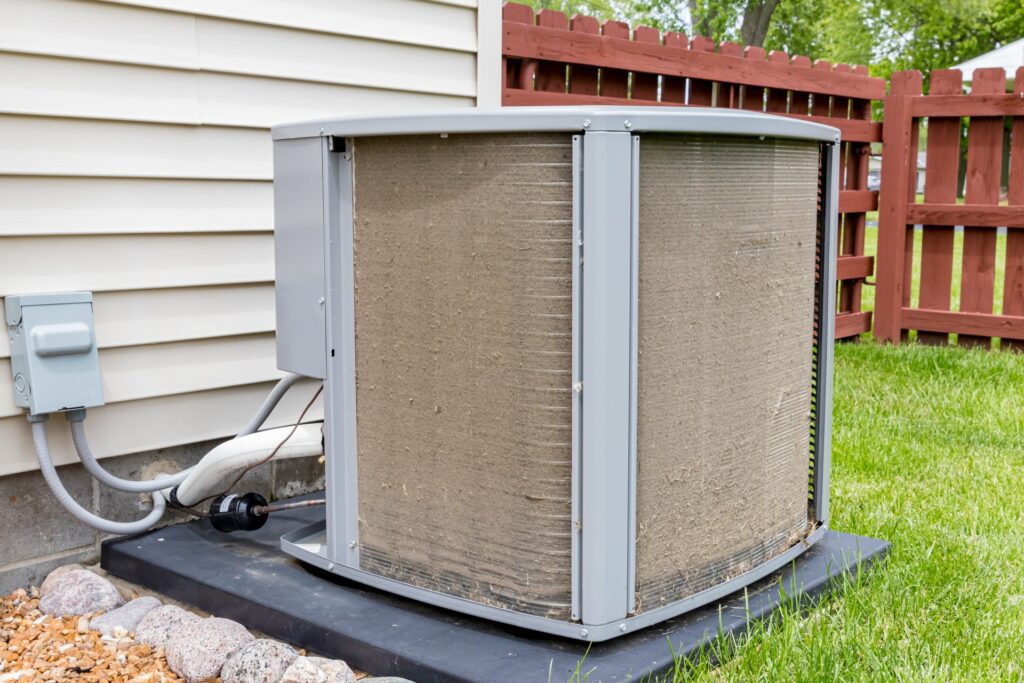 Dirty AC unit outside of a house