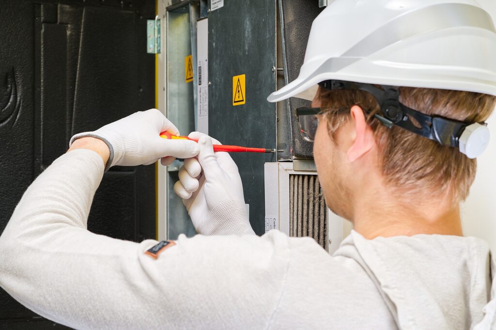 home central air system servicemen changing filter in furnace